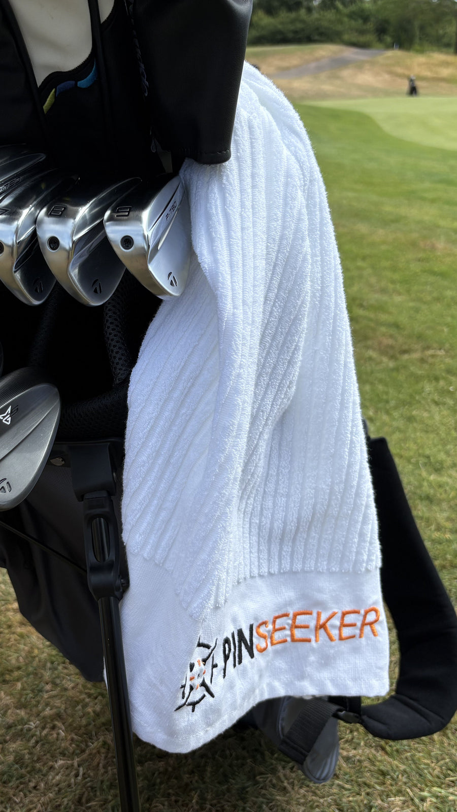 Caddy Golf Towel draped through the irons on a UK course
