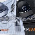 PINSEEKER Founders Squadron caps and caddy towels laid out in both Whiteout and Blackout