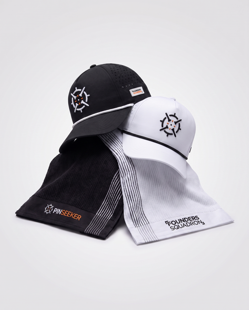 PINSEEKER Founders Squadron caps and caddy towels draped together in Blackout and Whiteout