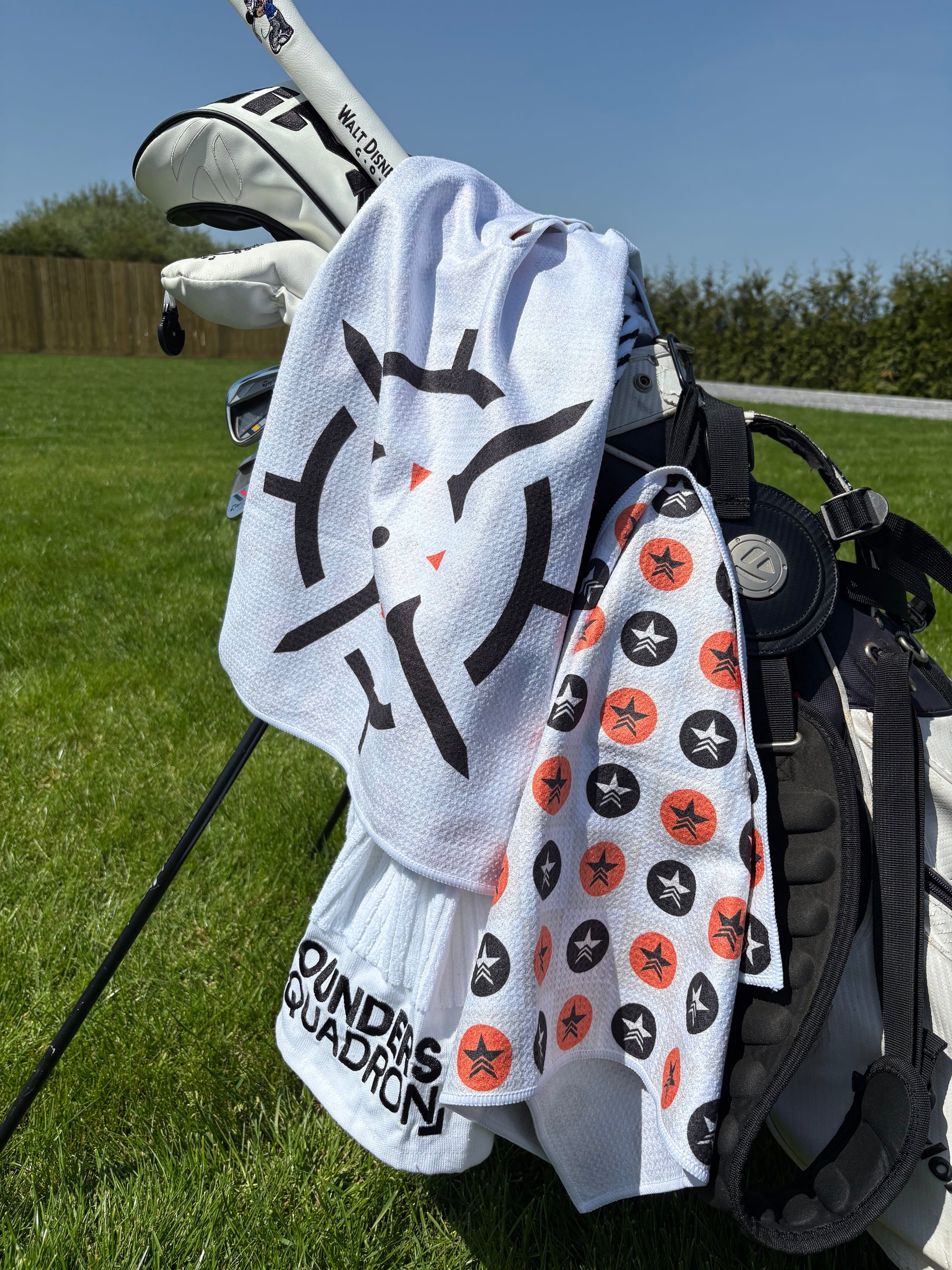 PINSEEKER Whiteout Founders Squadron caddy towel and star-print towel on a golf stand bag