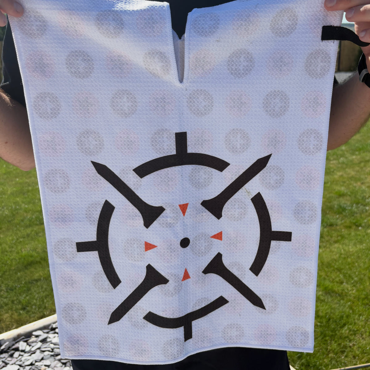 PINSEEKER golf towel in Whiteout, held up to show the target print